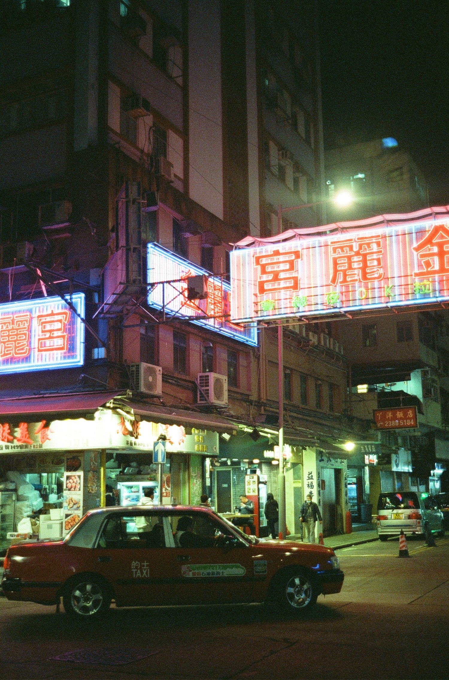 City street with bright neon signs taken on MISO 400 high grain film.