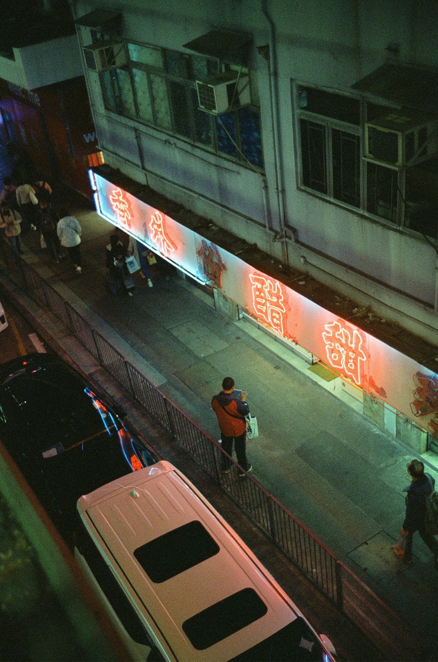 Building illuminated by neon lights shot on MISO 400 film high grain.