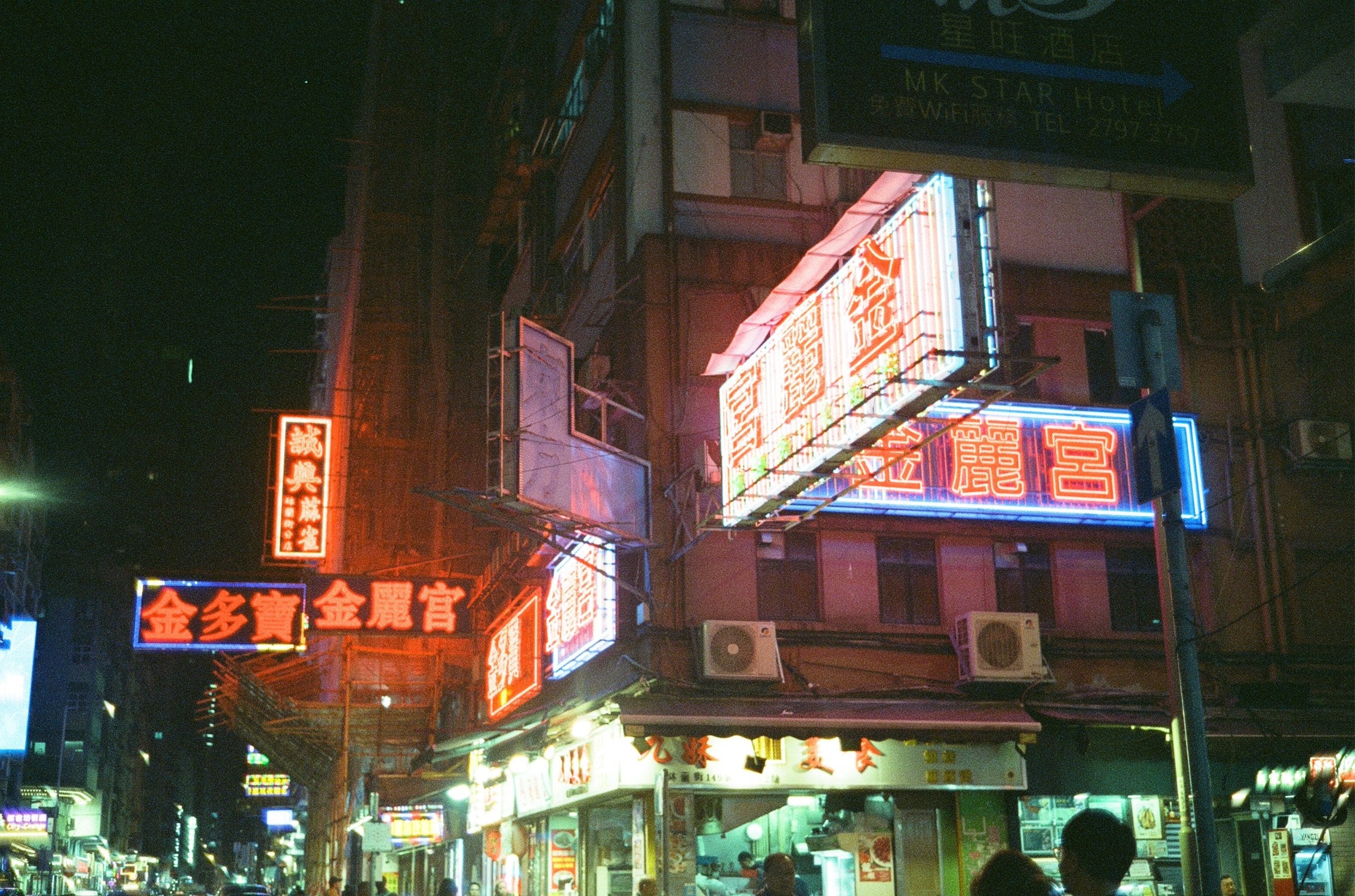 Neon-lit market captured at night on MISO 400 film high grain.