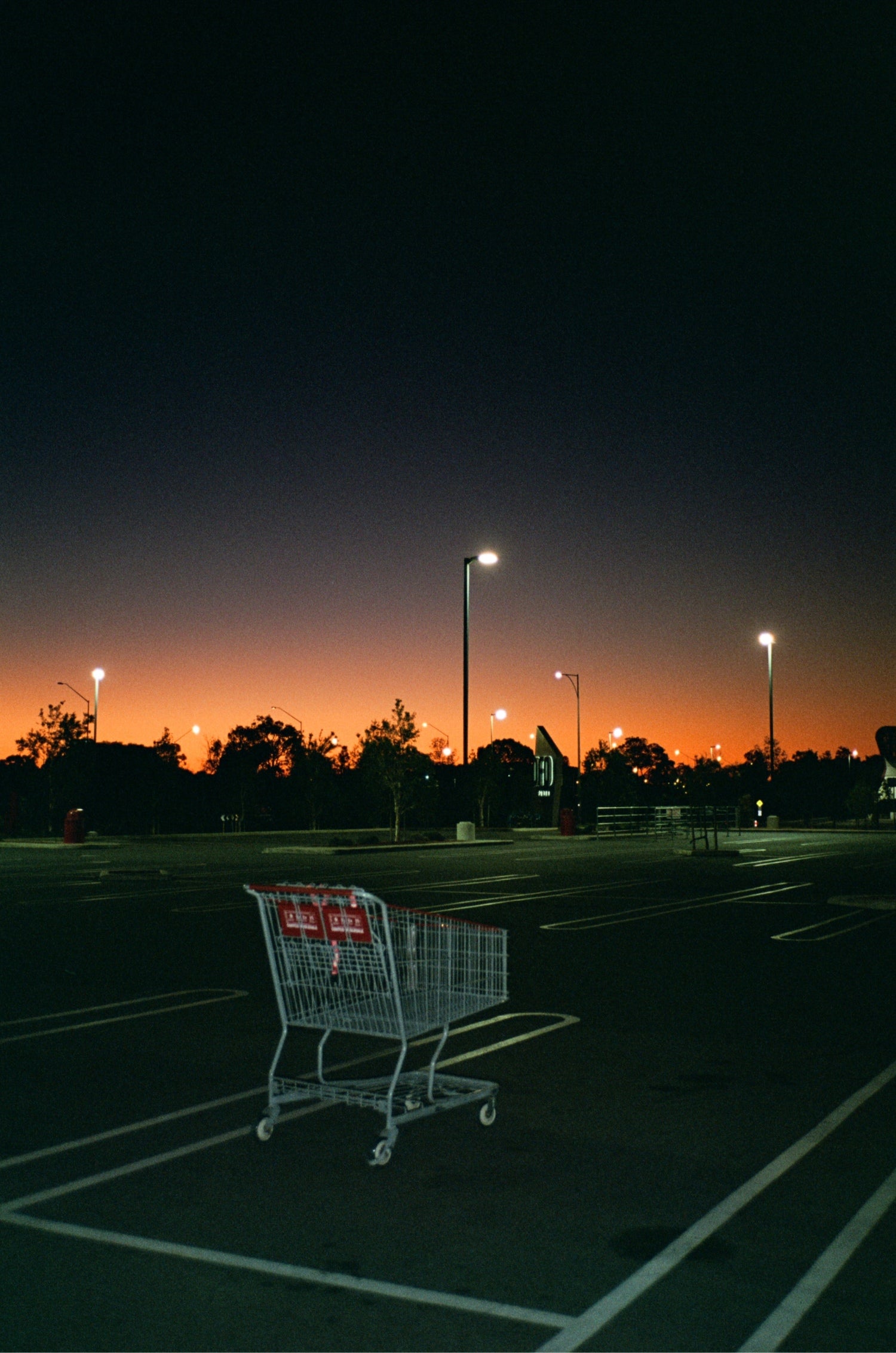 Shopping cart in parking lot at sunset shot on MISO 200 film with medium grain