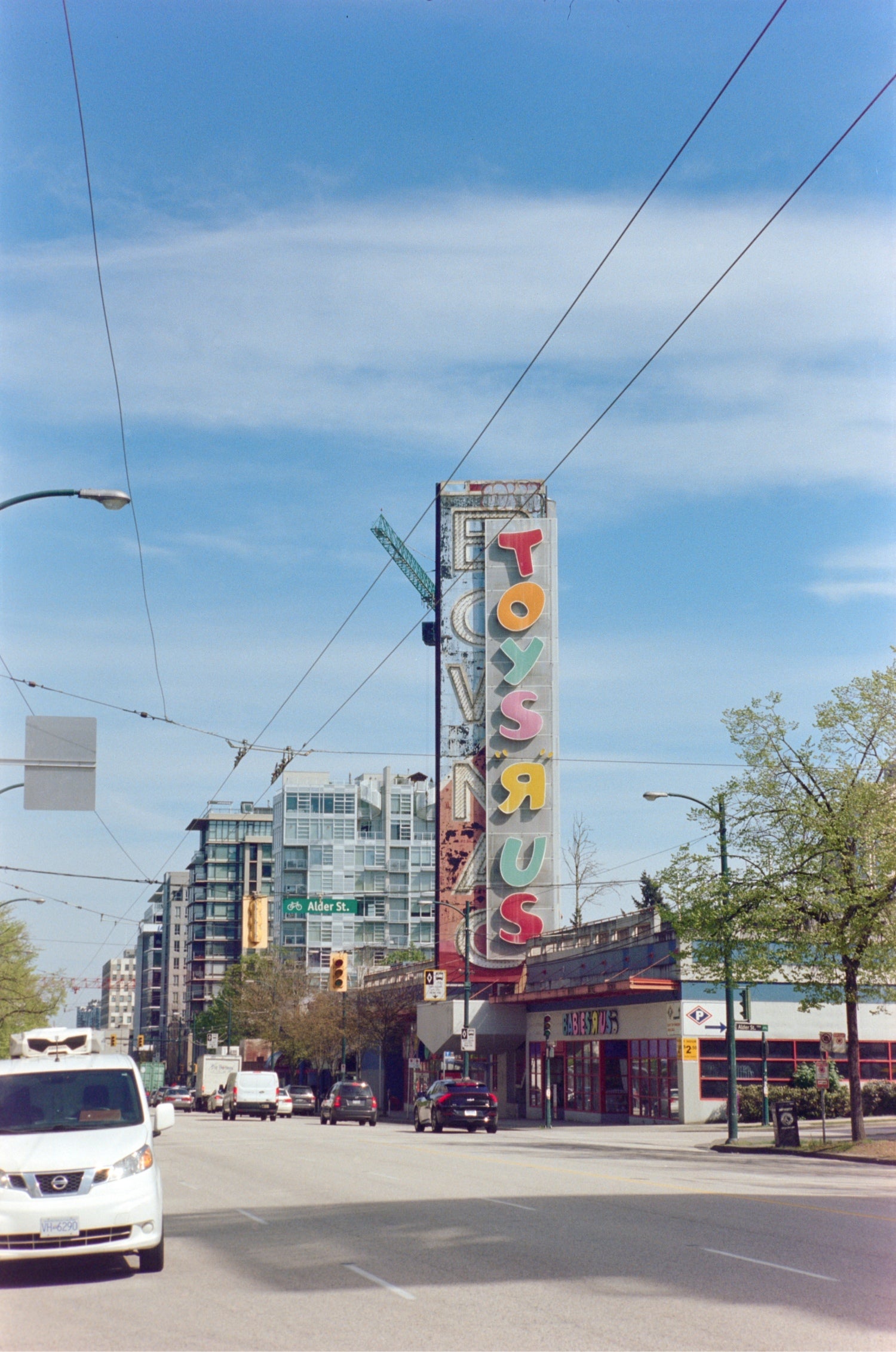 Vintage TOYS 'R' US sign in cityscape shot on MISO 200 film with medium grain